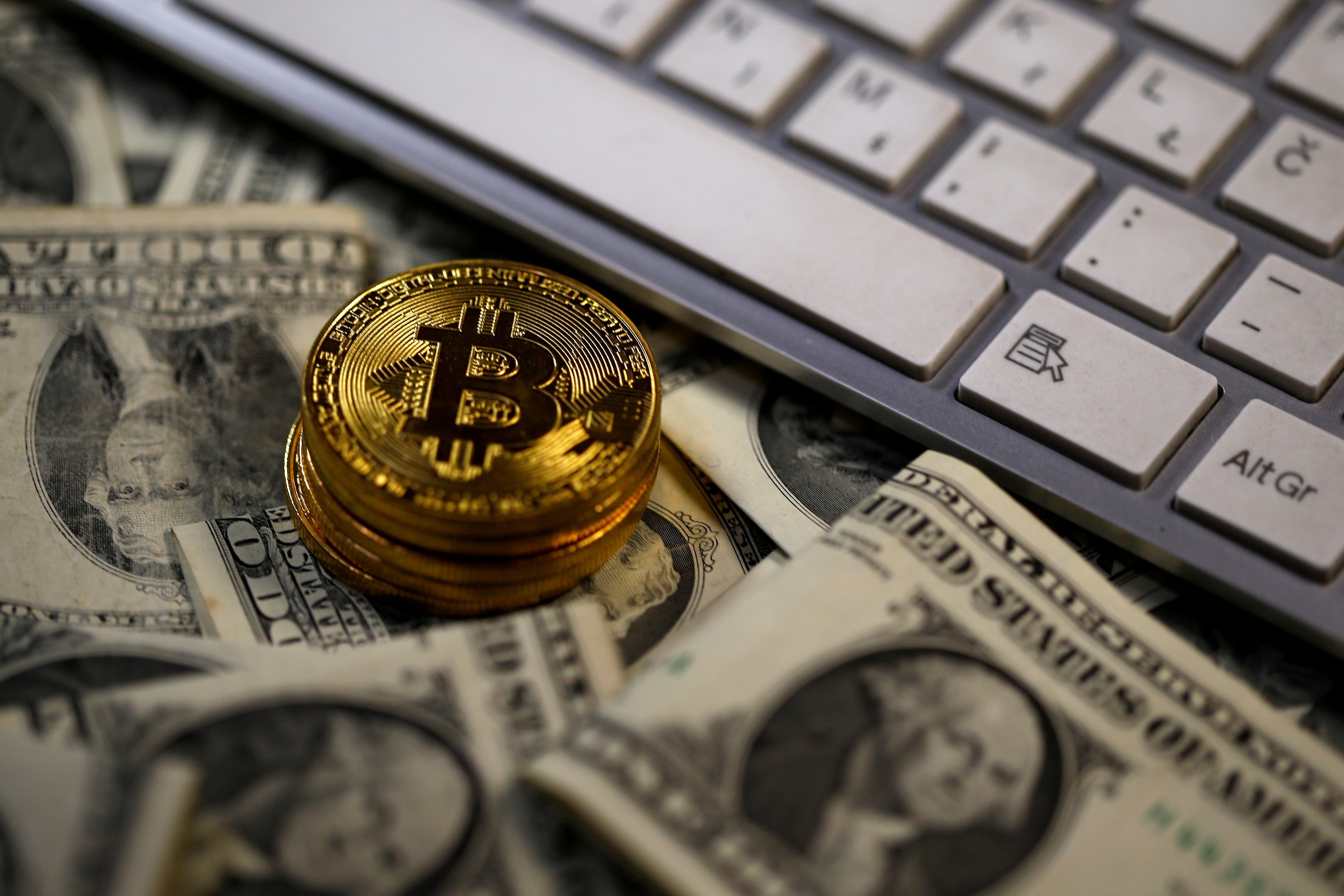 U.S. futures-based bitcoin ETF rises in first day of trading, bitcoin nears record | Reuters